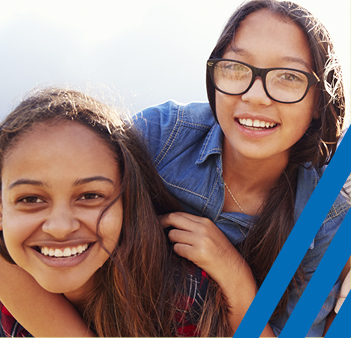 two girls hugging and smiling 