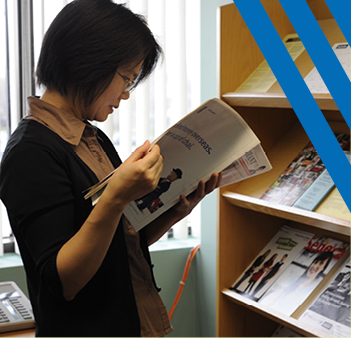 woman standing reading book