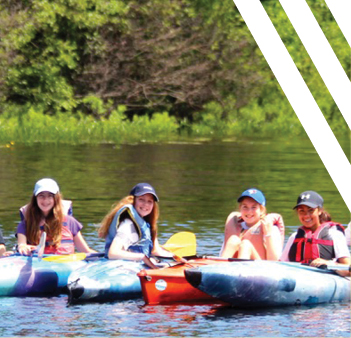 girls in kayaks in lake