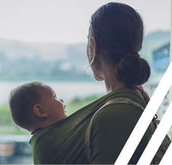 woman holding baby looking away