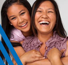 two women smiling and hugging