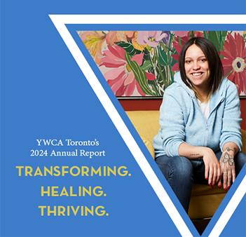 woman sitting in front of a painting of flowers, smiling