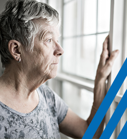 older woman staring out window