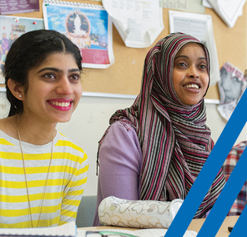 two women smiling in classroom