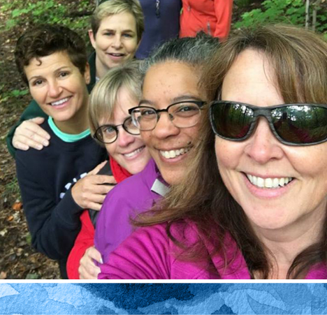 group of women outdoors smiling