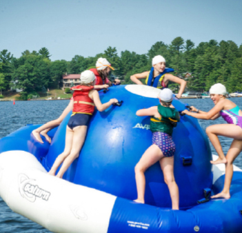 kids playing on large water floatie