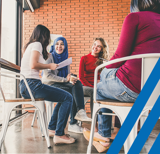 group of diverse women sitting at table 